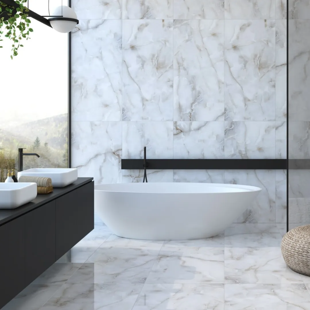 Bathroom with polished white marble-effect tiles on the walls and floor, a freestanding bath and a black wall-hung vanity with two basins